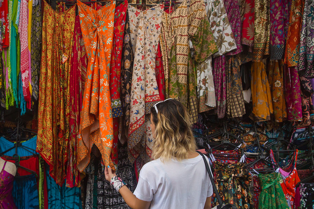 a girl looking at patterned dresses